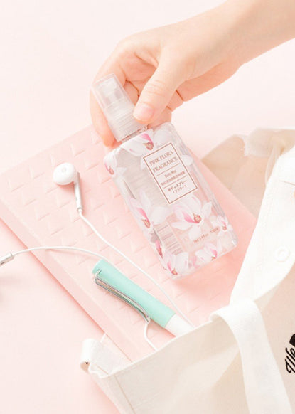 person placing perfume bottle into We Bare Bears bag along with headphones, notebook and utensils